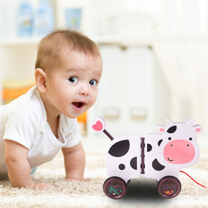 Jucarie interactiva Tip Vacuta Happy Cow idealSTORE, Dimensiune 18 x 19 x 9 cm, Dotata cu Sfoara Fabricat din plastic de inalta calitate, Roti inconjurate cu cauciuc, Pline cu bile, Posibilitatea de a se separa in 2 parti