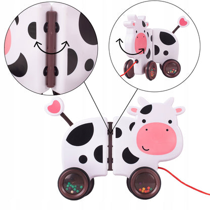 Jucarie interactiva Tip Vacuta Happy Cow idealSTORE, Dimensiune 18 x 19 x 9 cm, Dotata cu Sfoara Fabricat din plastic de inalta calitate, Roti inconjurate cu cauciuc, Pline cu bile, Posibilitatea de a se separa in 2 parti