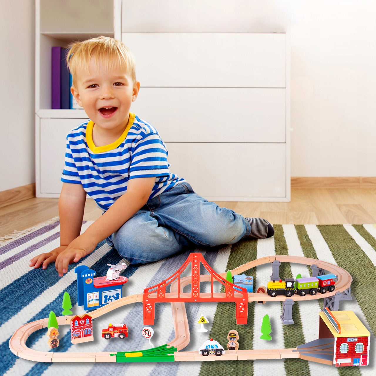 Pista Multifunctionala Merry Train idealSTORE din Lemn Natural, Construita din 70 de piese, Locomotiva + 2 vagoane cu magnet, Elicopter cu elice, Heliport, Detasament de Pompieri, Politie, Copaci, Indicatoare rutiere, Oameni, Piese Slefuite fin din lemn