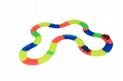 Set pista magica idealSTORE Fluorescent Track, Pista flexibila formata din 220 de elemente fluorescente, Include 3 masinute echipate cu luminite LED, Excelenta pentru orice varsta